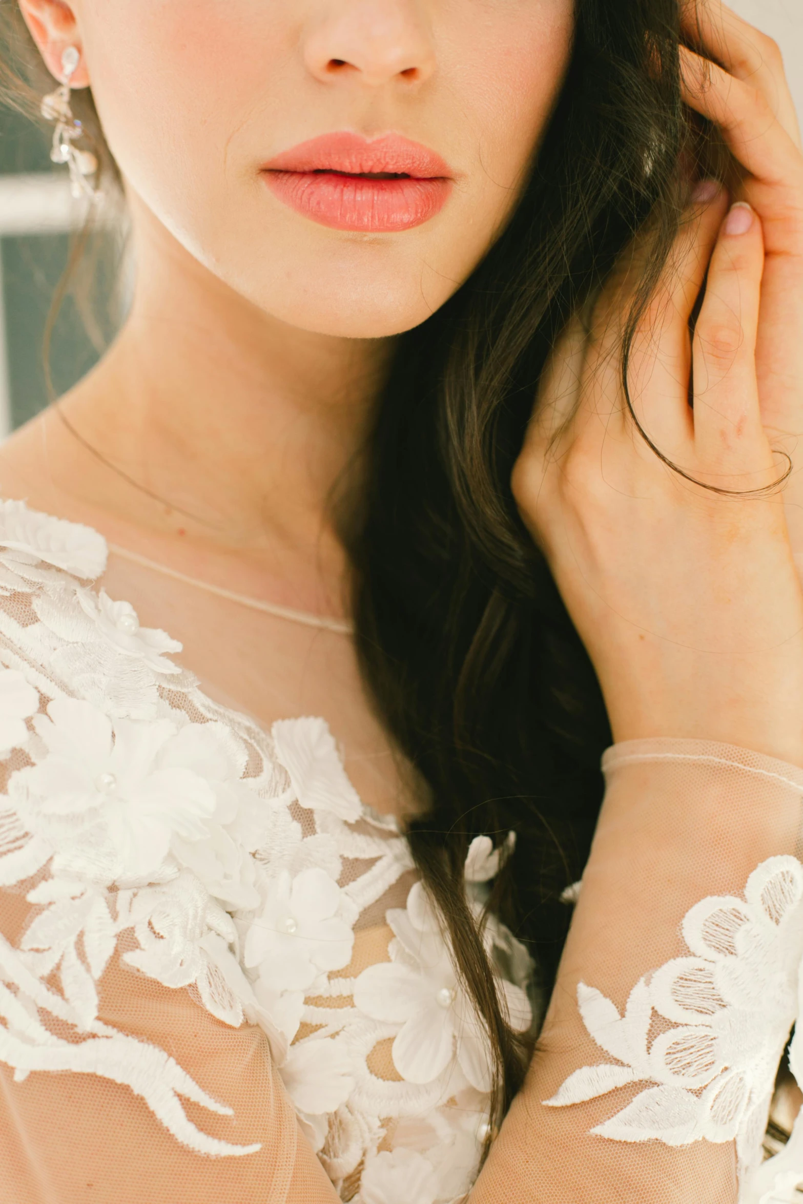 a close up of a woman wearing a wedding dress, a digital rendering, trending on pexels, coral, hand on cheek, white sleeves, mai anh tran