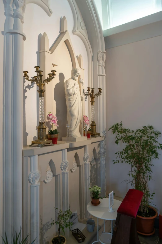 a small altar with a statue and potted plants, art nouveau, high arches, very very elegant, peaceful