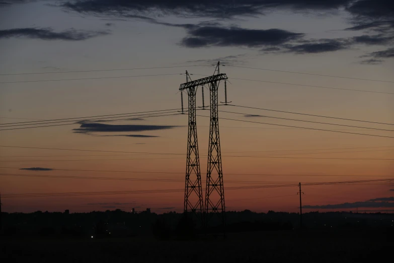 a very tall tower sitting in the middle of a field, by Adam Szentpétery, pexels contest winner, wires with lights, dusk, panorama, utility