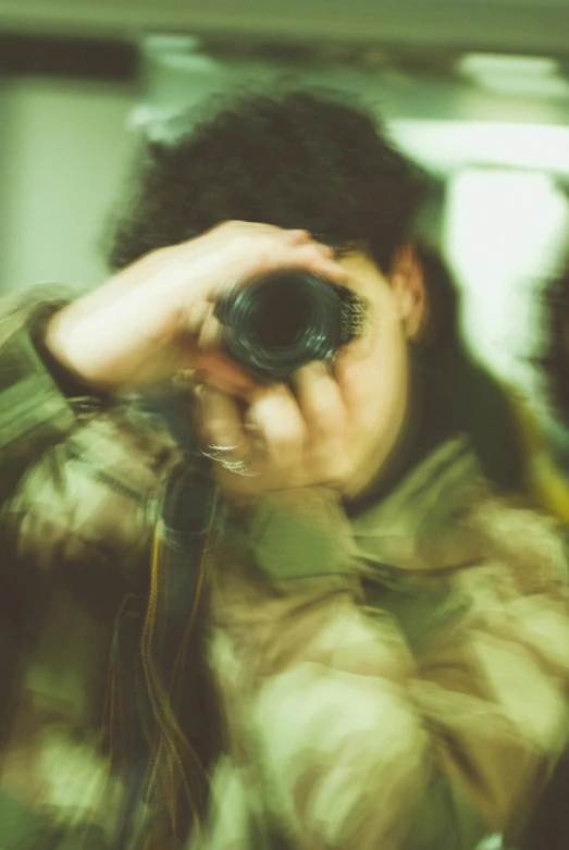 a woman taking a picture of herself in a mirror, a picture, inspired by Elsa Bleda, visual art, a soldier aiming a gun, lens zooming, close-up!!!!!, taken on a 2000s camera