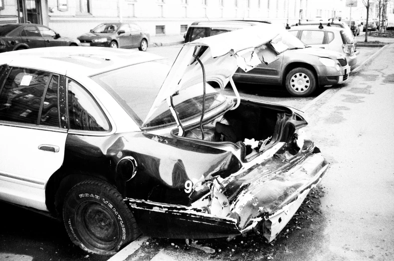 a black and white photo of a wrecked car, pexels, square, traffic accident, ready - made, lowres