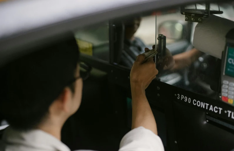 a man that is sitting in the driver's seat of a car, a picture, by Carey Morris, pexels contest winner, vintage footage on tokyo streets, taxi, white mechanical details, manila