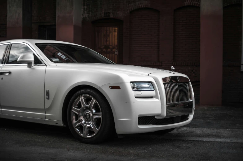 a white rolls royce parked in front of a building, by Alexander Robertson, pexels contest winner, renaissance, with a white muzzle, featuring rhodium wires, 2 0 % pearlescent detailing, square
