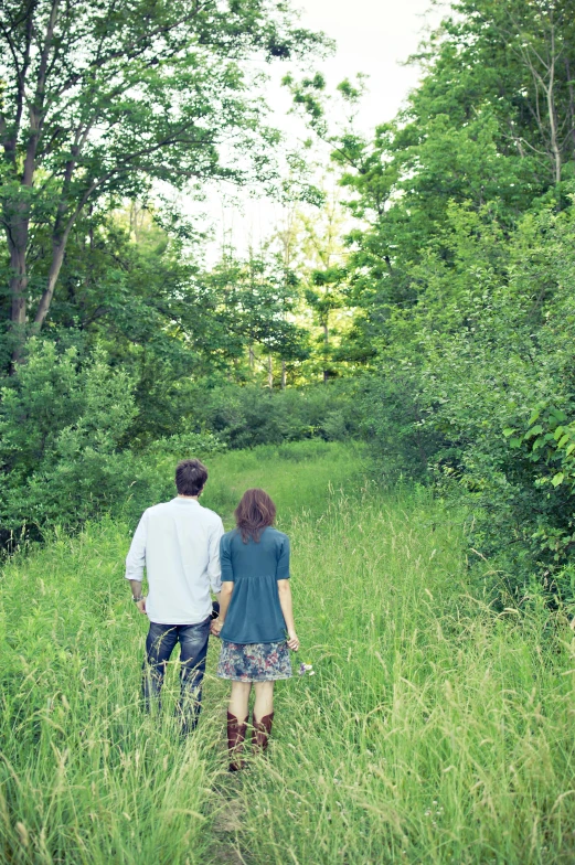 a couple of people that are walking in the grass, lush trees, secluded, overgrown greenery, instagram picture