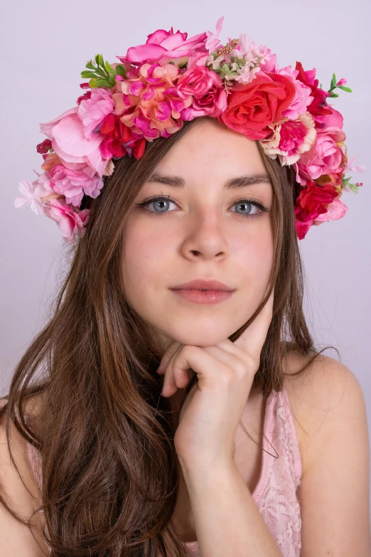 a woman with a flower crown on her head, a colorized photo, by Marie Angel, shutterstock contest winner, beautiful alluring teen, pink studio lighting, lovingly looking at camera, hyperrealistic teen