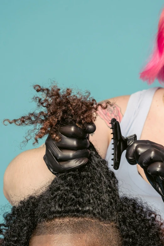 a woman with pink hair cutting another woman's hair, an album cover, trending on pexels, renaissance, wearing gloves, closeup of arms, black main color, casey weldon