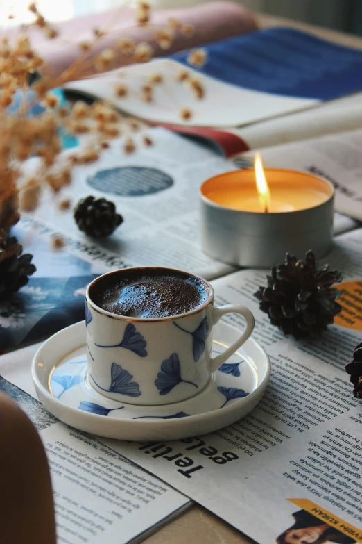 a cup of coffee sitting on top of a table, blue and grey theme, candles, turkey, profile image