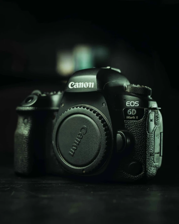 a camera sitting on top of a wooden table, unsplash contest winner, canon eos 6d, covered with tar. dslr, on black background, full body profile camera shot