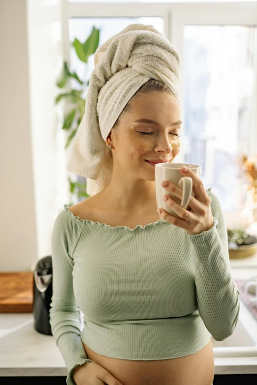 a pregnant woman drinking a cup of coffee, pexels contest winner, renaissance, wearing a towel, skincare, profile image, green tea