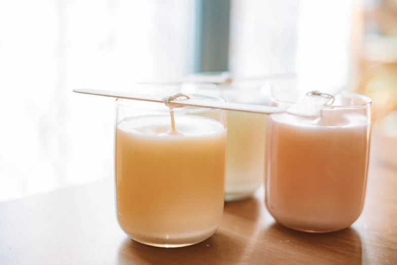 two candles sitting next to each other on a table, sustainable materials, soymilk, thumbnail, fan favorite