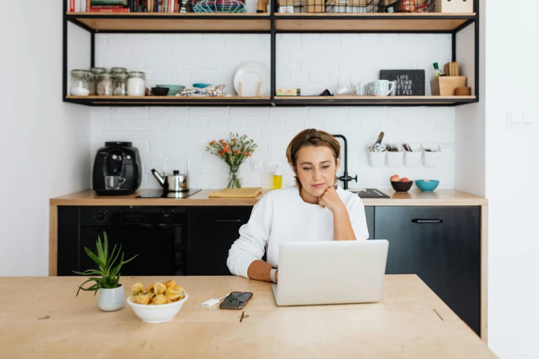 a woman sitting at a kitchen table with a laptop, a portrait, trending on pexels, avatar image, inspect in inventory image, chef table, completely empty