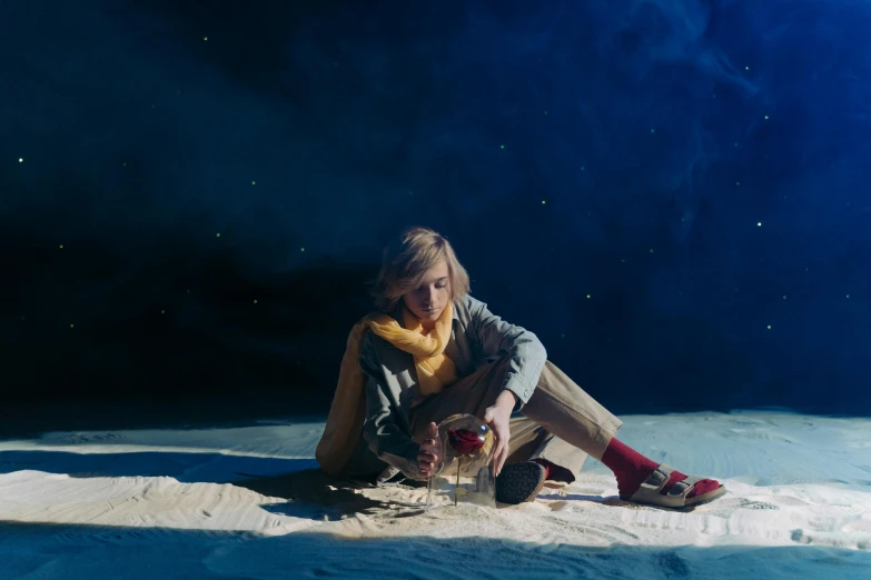 a woman sitting on top of a snow covered ground, an album cover, by Lee Gatch, unsplash contest winner, magical realism, kiernan shipka, on a spaceship, laying on sand, still from a wes anderson film