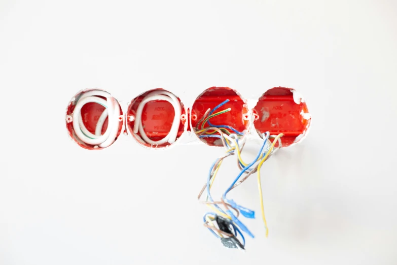 a close up of a bunch of wires on a wall, by Nicolette Macnamara, pexels, plasticien, white and red color scheme, on white background, sconces, listing image