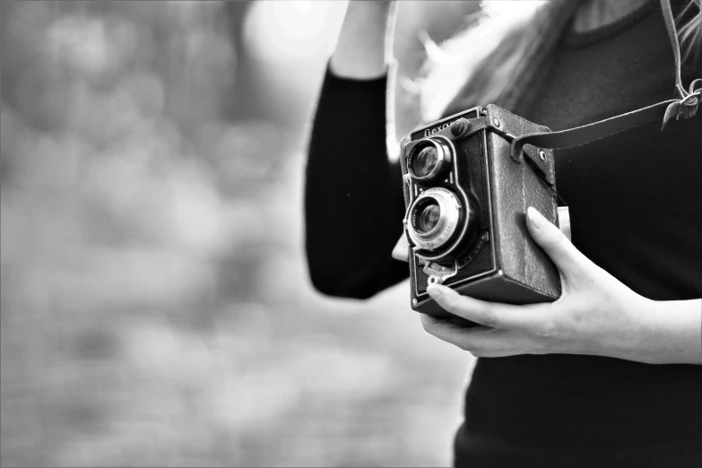 a black and white photo of a woman holding a camera, a black and white photo, art photography, rolleiflex tlr, fineartamerica, small, !!! colored photography
