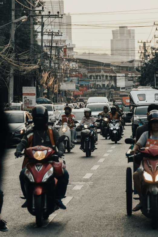 a group of people riding motorcycles down a street, manila, fan favorite, ultrawide cinematic, paisley