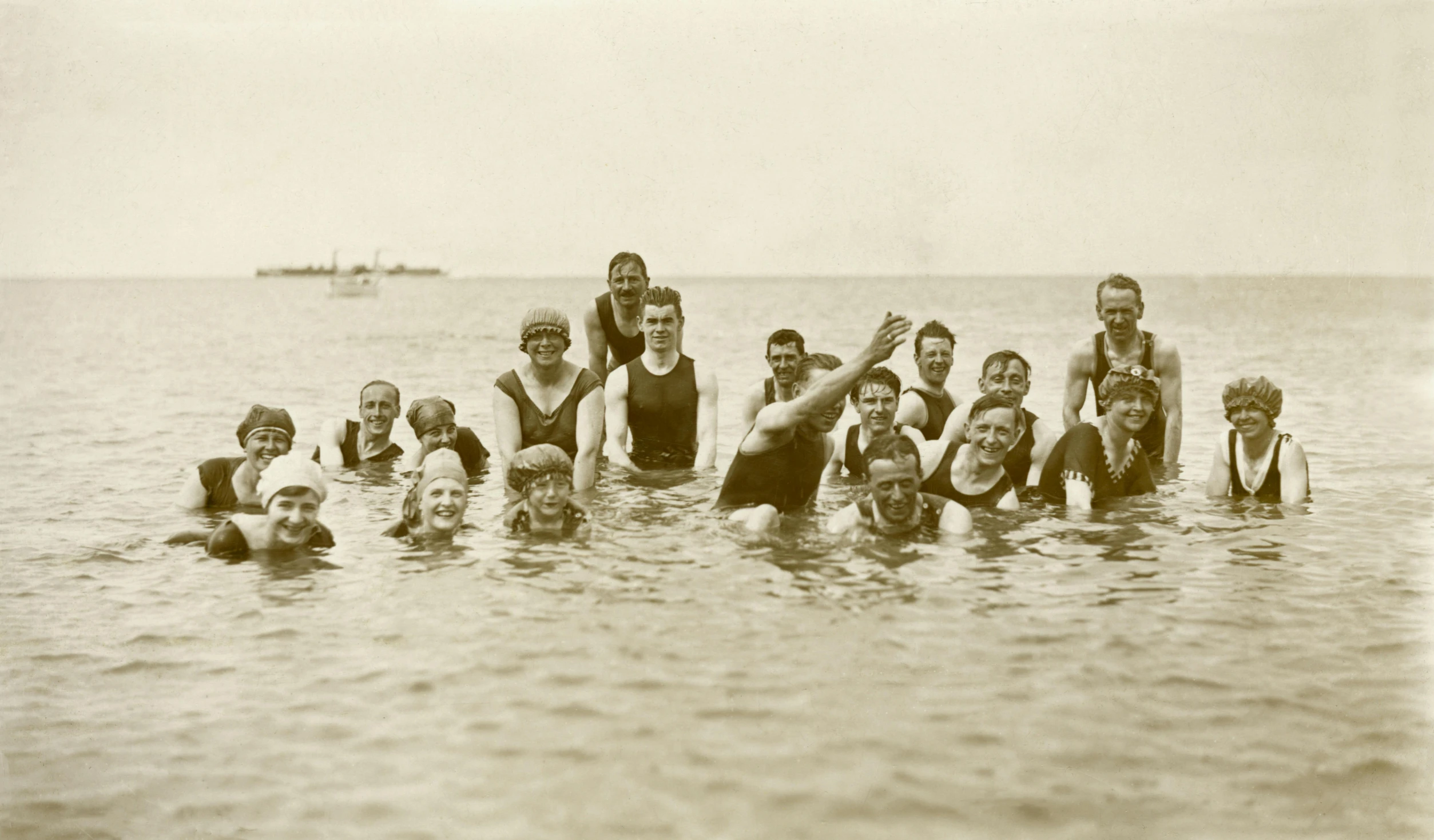 a group of people standing in a body of water, inspired by Walter Beach Humphrey, flickr, roaring 20s, group photo, swimming in ocean, holiday season