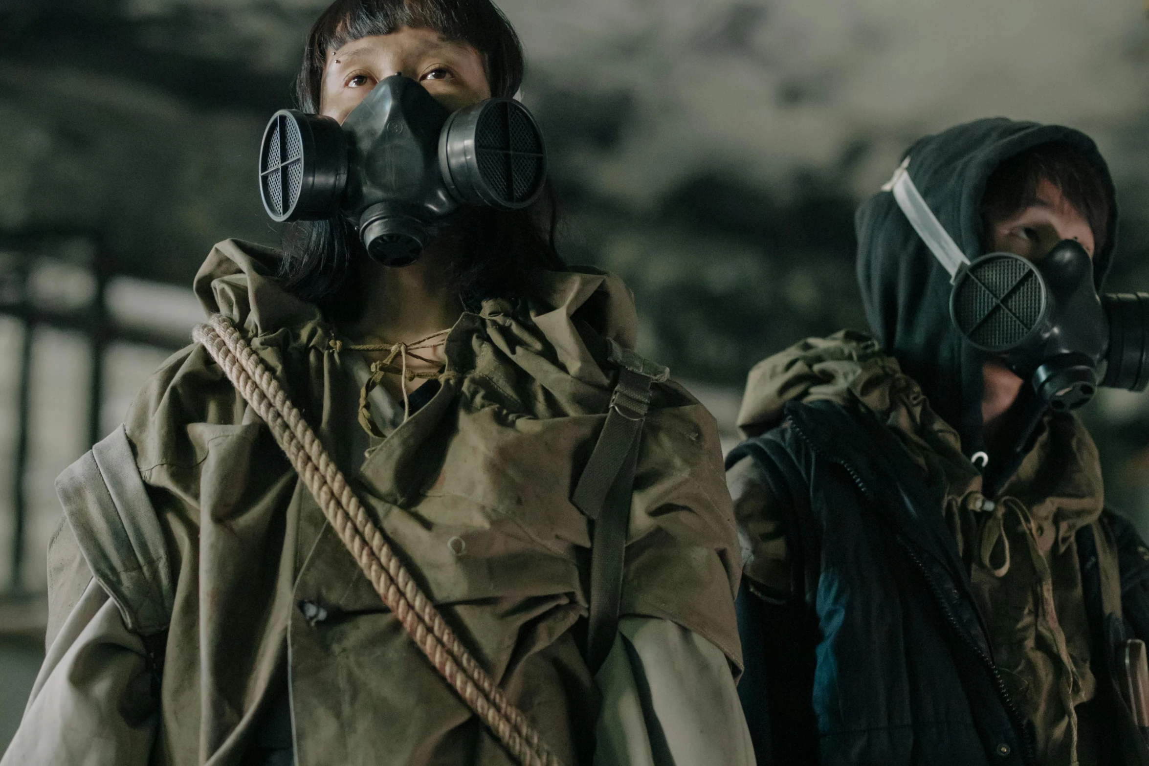 two people wearing gas masks standing next to each other, inspired by Yoshihiko Wada, pexels contest winner, mingei, film still dnd movie, wearing dirty travelling clothes, jaeyeon nam, [ theatrical ]