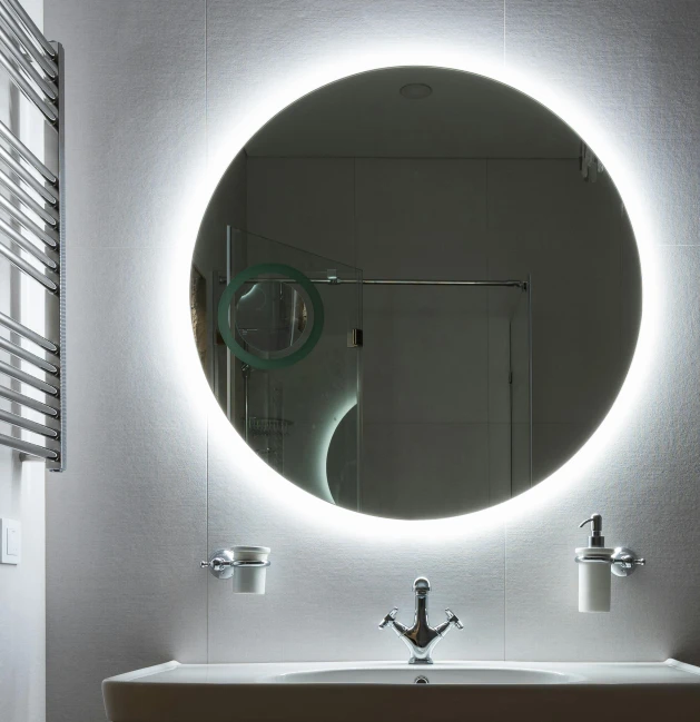 a bath room with a sink a mirror and a radiator, inspired by Edo Murtić, ring lighting, circular white full moon, direct lighting, fluorescent led