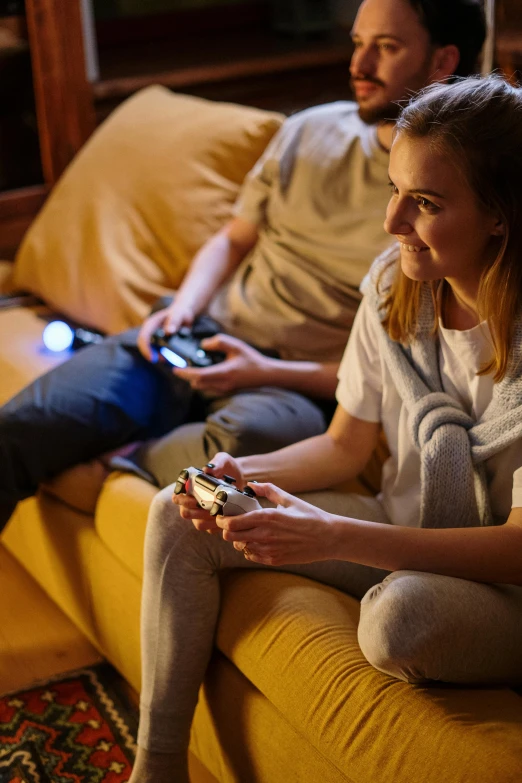 a man and a woman sitting on a couch playing video games, warm ambient lighting, promo image, bottom angle, xbox