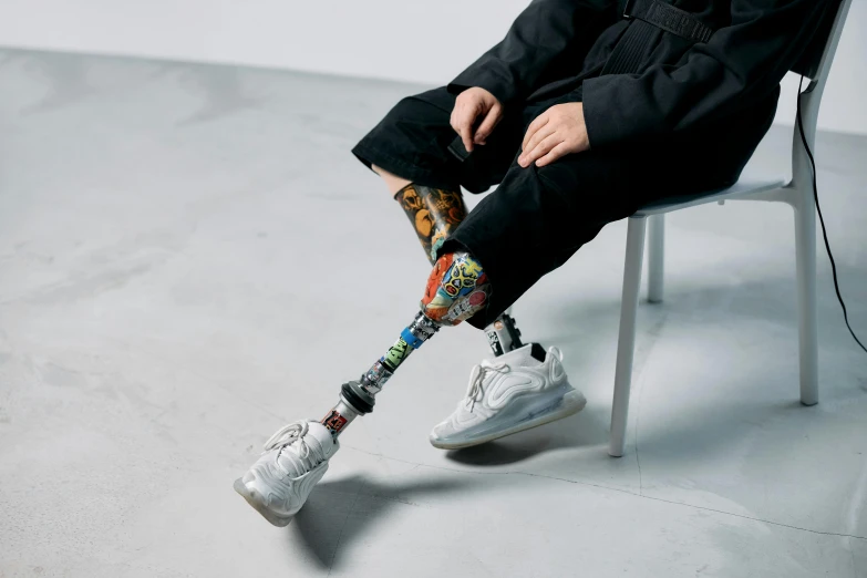 a man with a broken leg sitting on a chair, inspired by Fei Danxu, unsplash, hyperrealism, takashi murakami art style, wearing bionic implants, multicoloured, off - white collection