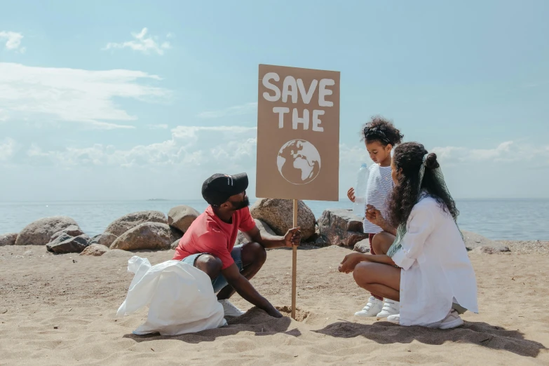 a group of people sitting on top of a sandy beach, pexels contest winner, environmental art, protesters holding placards, avatar image, pregnancy, 3 - piece