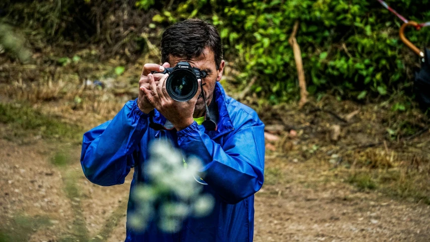 a man taking a picture with a camera, a picture, inspired by Steve McCurry, pexels contest winner, art photography, photograph captured in the woods, today\'s featured photograph 4k, full frame image, action photograph
