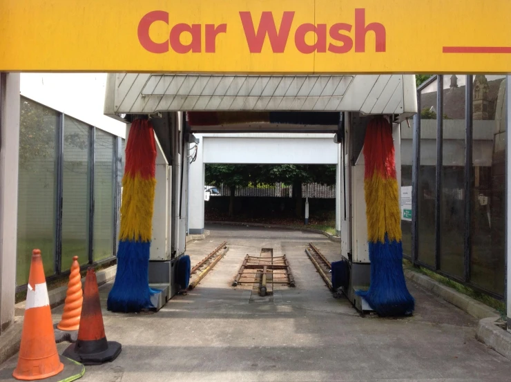 a car wash station with orange cones in front of it, by Alejandro Obregón, 15081959 21121991 01012000 4k, sao paulo, multi - coloured, wash