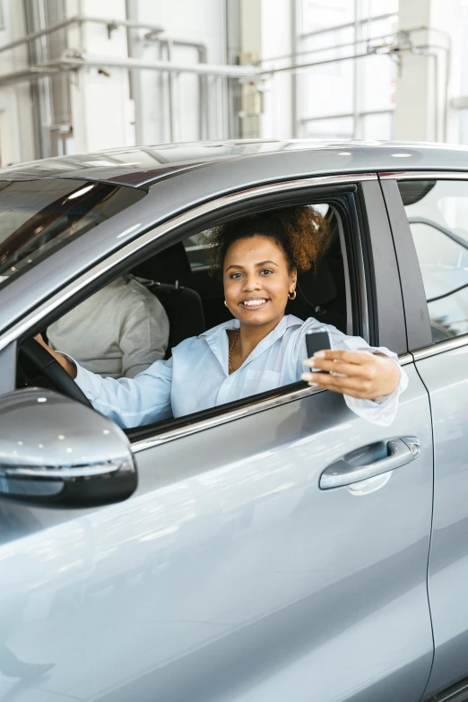 a woman sitting in a car holding a cell phone, posing for a picture, square, selling insurance, dark-skinned