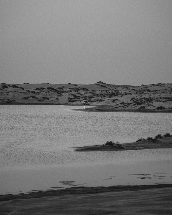 a black and white photo of a body of water, sahara, dakar, in the evening, the see horse valley