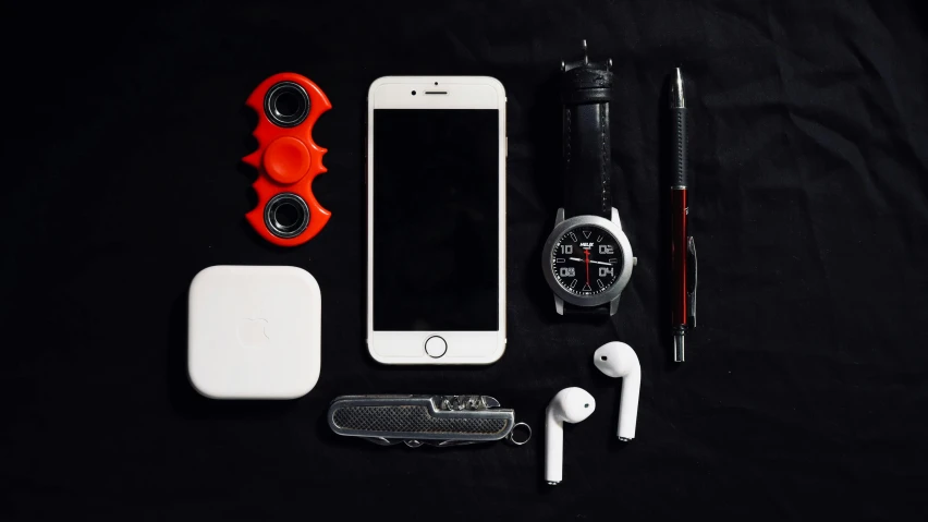 a white cell phone sitting on top of a black table, a still life, by Matthias Stom, trending on pexels, airforce gear, white red, knolling, various items