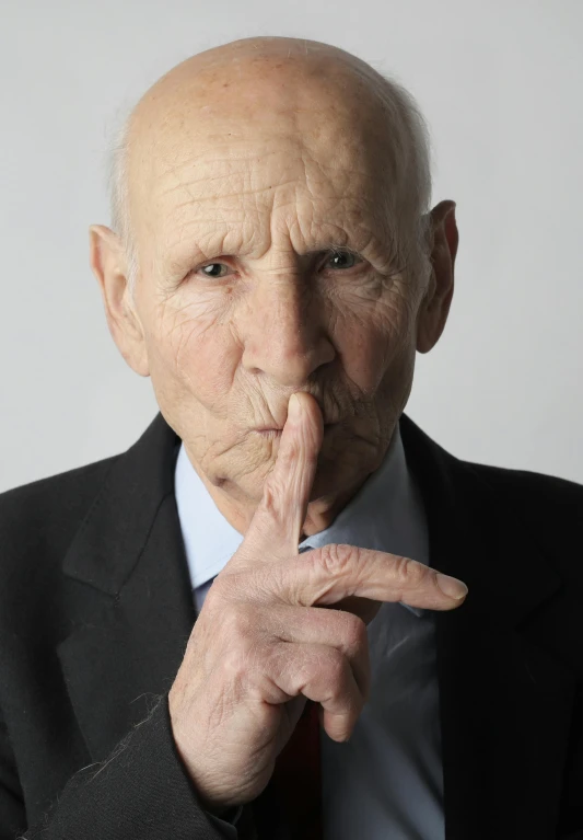 a close up of a person wearing a suit and tie, by Karl Ballmer, hand over mouth, an 80 year old man, promo photo, silence
