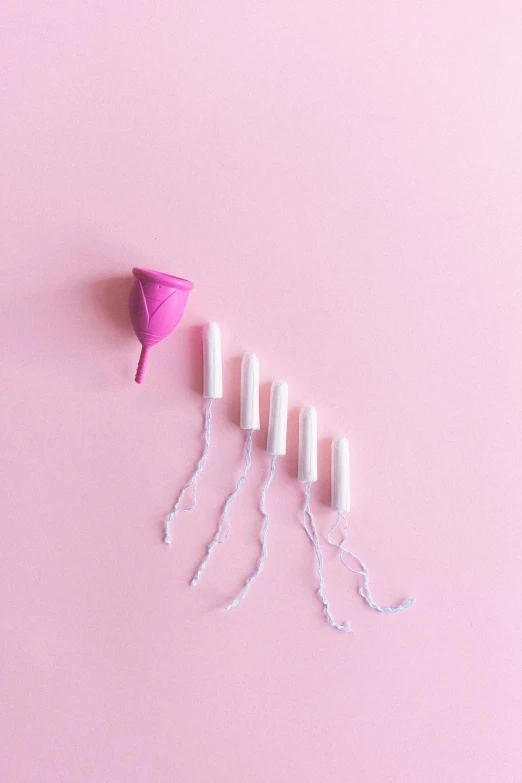 a pink cone sitting on top of a pink surface, contracept, wrapped in wires and piones, ad image, pods