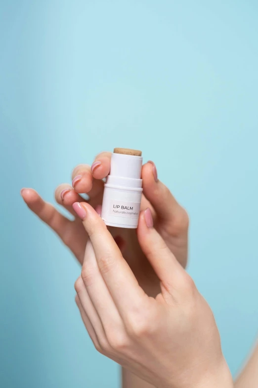 a close up of a person holding a bottle of lotion, lipstick, uploaded, product, small