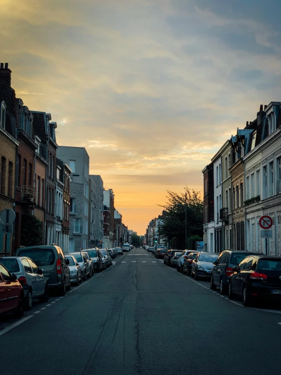 a street filled with lots of parked cars, by Jan Tengnagel, pexels contest winner, renaissance, late summer evening, normandy, profile image, sunlit sky