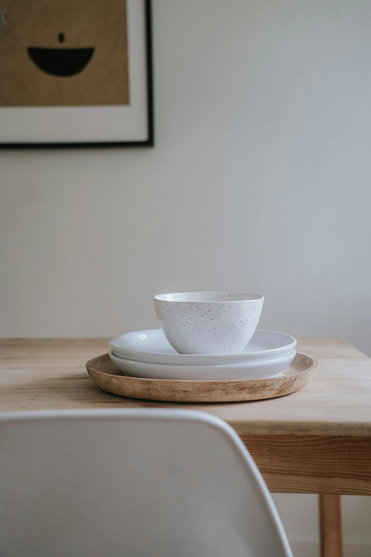 a white bowl sitting on top of a wooden table, by James Morris, pexels contest winner, table in front with a cup, white kitchen table, grey, vanilla