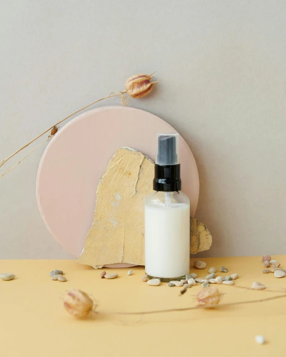 a bottle of lotion sitting on top of a table, inspired by Agnes Martin, unsplash, jakarta, lacquer on canvas, solar punk product photo, thumbnail