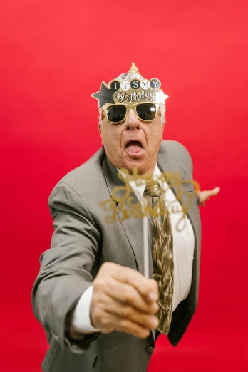 a man in a suit with a crown on his head, an album cover, inspired by John Maxwell, unsplash, stuckism, danny devito as johnny, gold glasses, everyone having fun, ron perlman