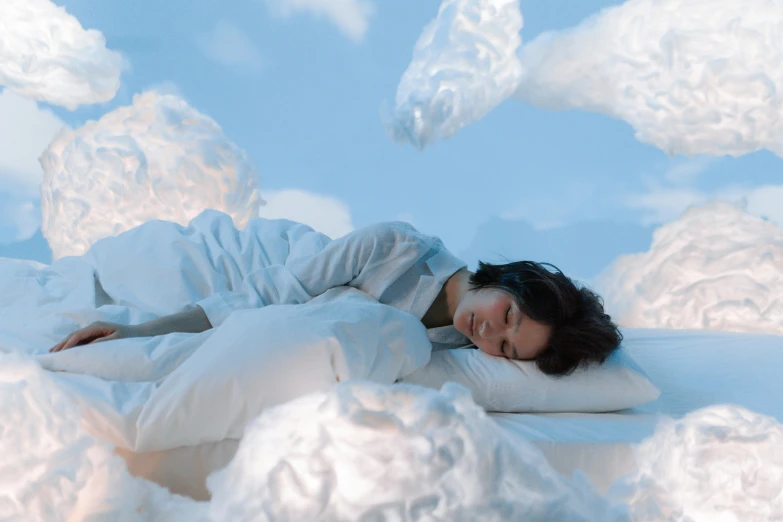 a woman laying on top of a cloud covered bed, inspired by Fei Danxu, pexels contest winner, humans sleeping in healing pods, sachiko miyazaki, bedhead, promo image