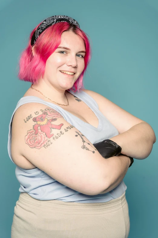 a woman with pink hair posing for a picture, a tattoo, inspired by Jessie Alexandra Dick, obese ), age 2 0, adafruit, high res photograph