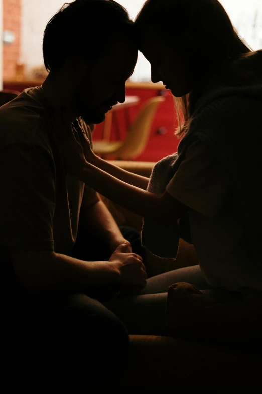 a couple of people sitting next to each other, inspired by Nan Goldin, trending on pexels, hurufiyya, praying, soft light 4k, 8 k movie still, embrace