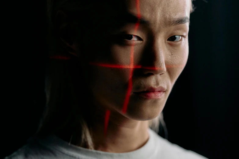 a woman with red lines on her face, a hologram, trending on pexels, asian man, focused light, sangsoo jeong, face scars