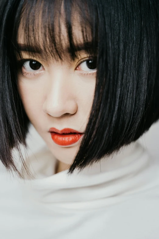 a close up of a person with a short hair, inspired by Itō Shinsui, trending on pexels, bangs, pout, vietnamese woman, square face