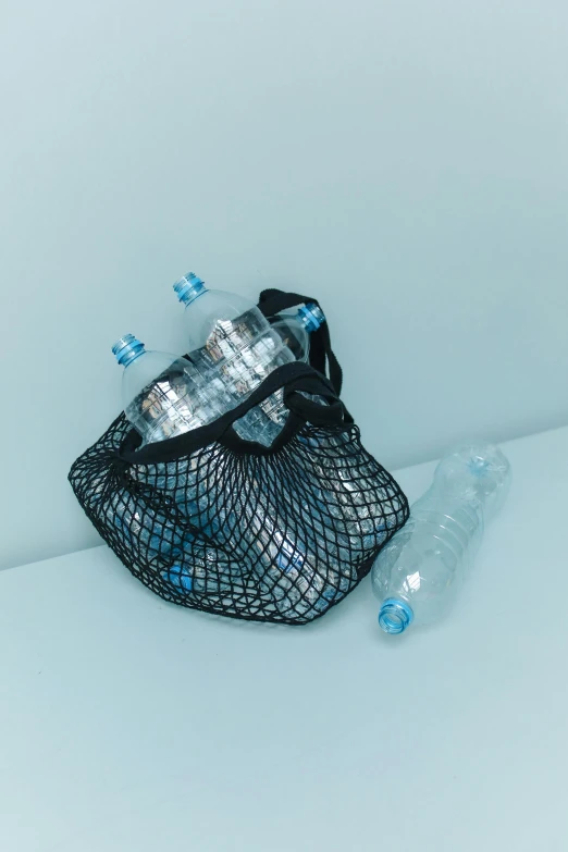 a mesh bag filled with bottles of water, unsplash contest winner, plasticien, blue and black scheme, y2k, high quality photo, concept photo