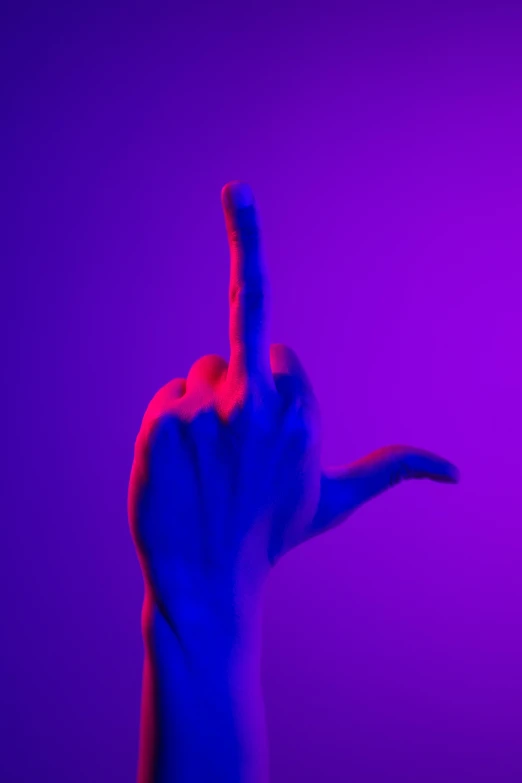 a person holding their hand up in the air, an album cover, inspired by Bruce Nauman, unsplash, conceptual art, purple and red, giving the middle finger, blue image, showstudio