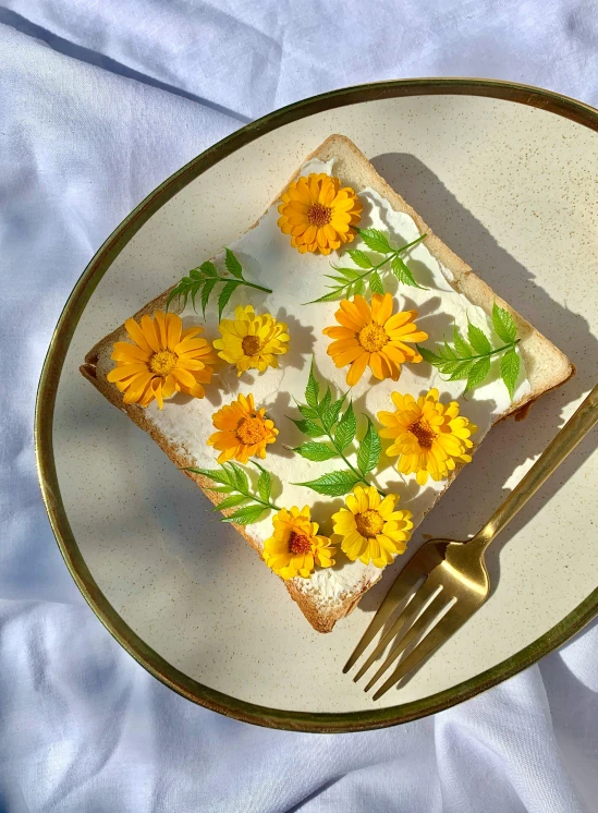 a white plate topped with a piece of cake covered in flowers, by Tan Ting-pho, unsplash, hyperrealism, toast, head made of giant daisies, yellow and greens, 👅 👅