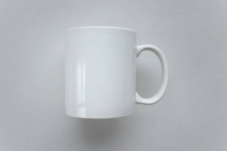 a white coffee cup sitting on top of a table, product image