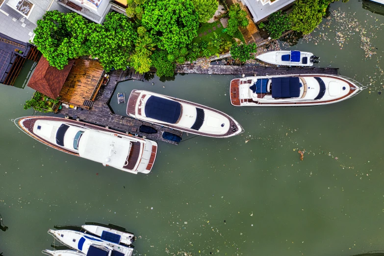 a group of boats sitting on top of a body of water, by Sebastian Vrancx, pexels contest winner, birds eye, bangkok, slide show, shaped like a yacht