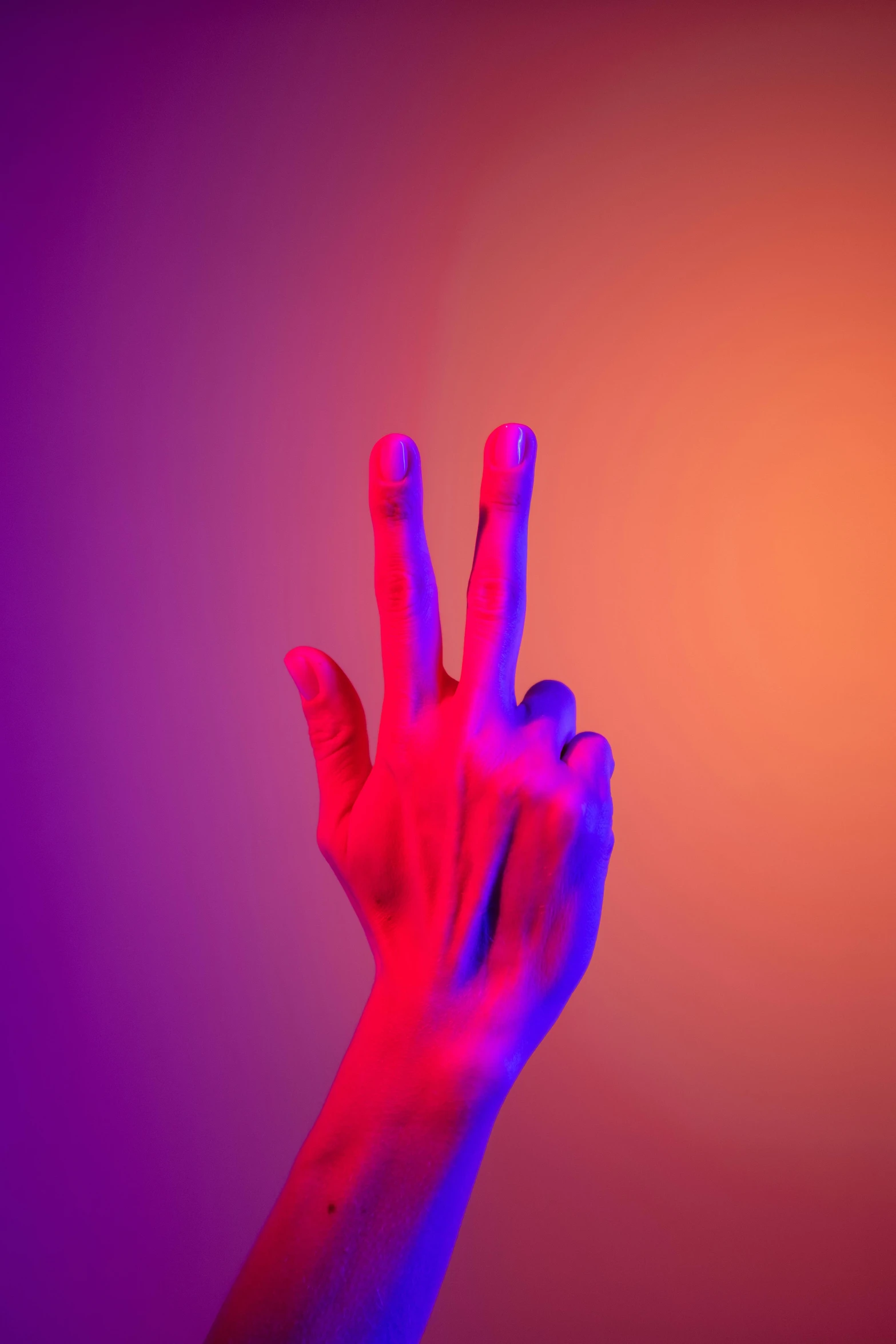 a person holding their hand up in the air, an album cover, by Joseph-Marie Vien, synchromism, orange and purple electricity, at peace, red and blue, giving the middle finger