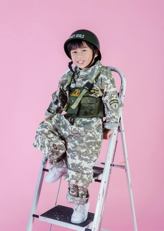 a little girl that is sitting on a ladder, an album cover, inspired by Kim Hwan-gi, pexels, dau-al-set, wearing tactical gear, digital camo, costume, military carrier rig