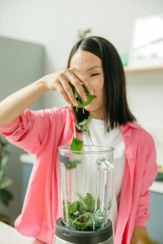 a woman is making a smoothie in a blender, trending on pexels, renaissance, spirited water plants, avatar image, half asian, acid leaking from mouth